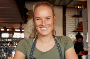 female waitress standing in a bar