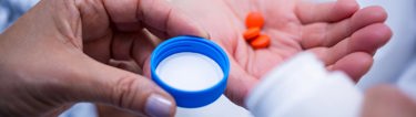 hand holding several pills
