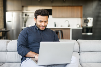 an image to show a man using e-learning platforms to improve his reflective practice 