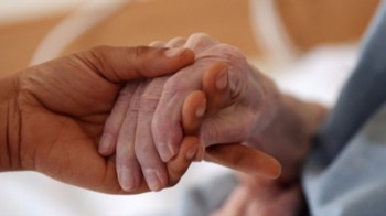 Image to show carer holding hands with older adult to show exampl of complex care