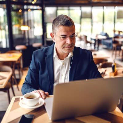 A man in a suit on a laptop