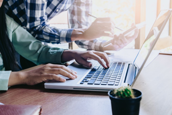 image of a man using data analytics on his laptop as part of reflective practice in healthcare