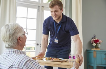 A carer with a client - an example of care delivered inside the ICS.