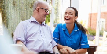 Image with an elderly person and a care worker