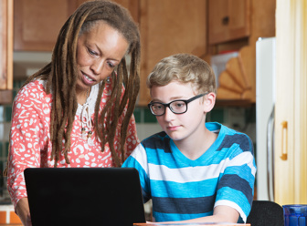 an image of a young boy with a link worker delivering social prescribing for children