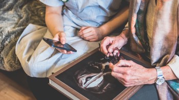 Carer showing patient their phone