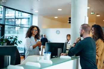 A receptionist accessing shared care records, made possible through integrated technology.