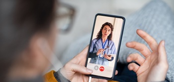 A patient and nurse on a video call to discuss care.