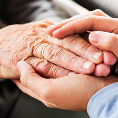 A picture of two people holding hands 