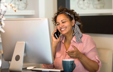 A woman smiling on her phone