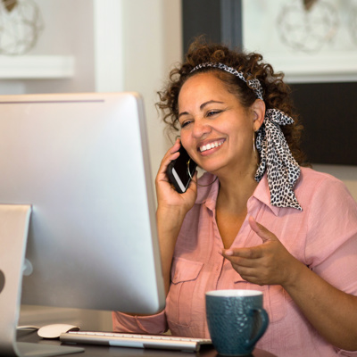 A woman smiling on her phone