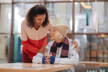 image of a woman supporting a homeless woman to represent what is homelessness