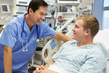 Doctor talking to patient in a bed